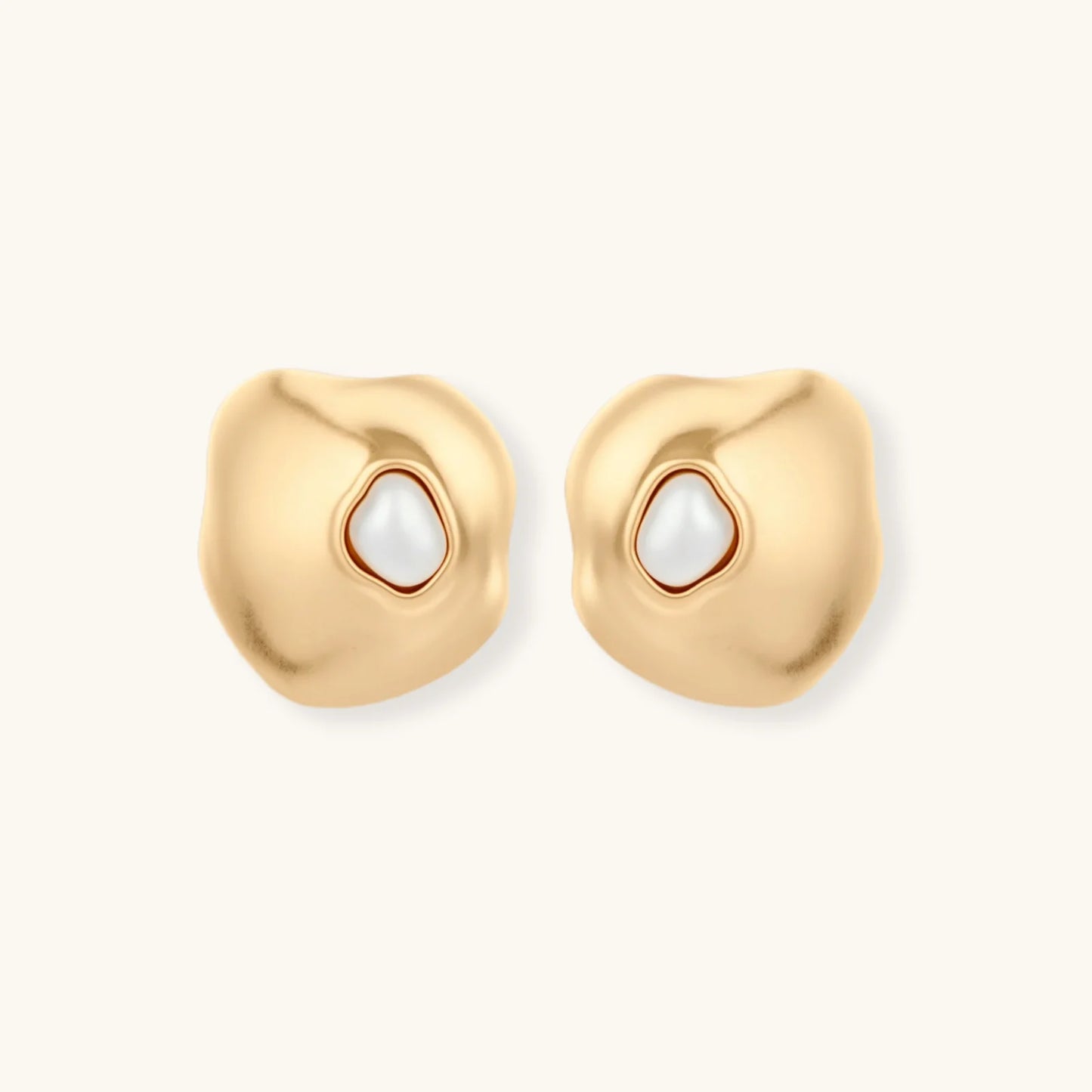 Organic-shaped eco-zinc alloy stud earrings with resin pearl centers and sterling silver posts on white background.