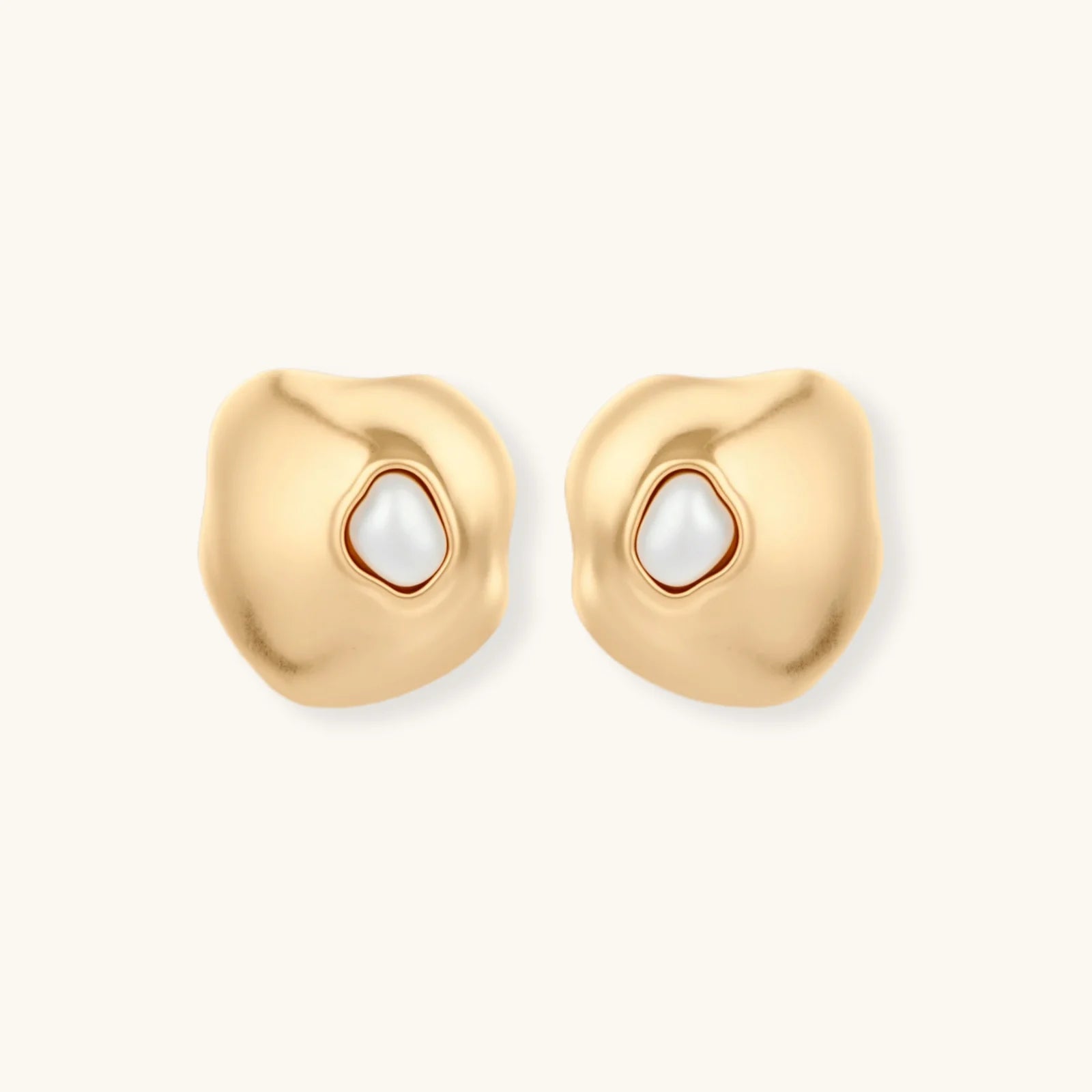 Organic-shaped eco-zinc alloy stud earrings with resin pearl centers and sterling silver posts on white background.