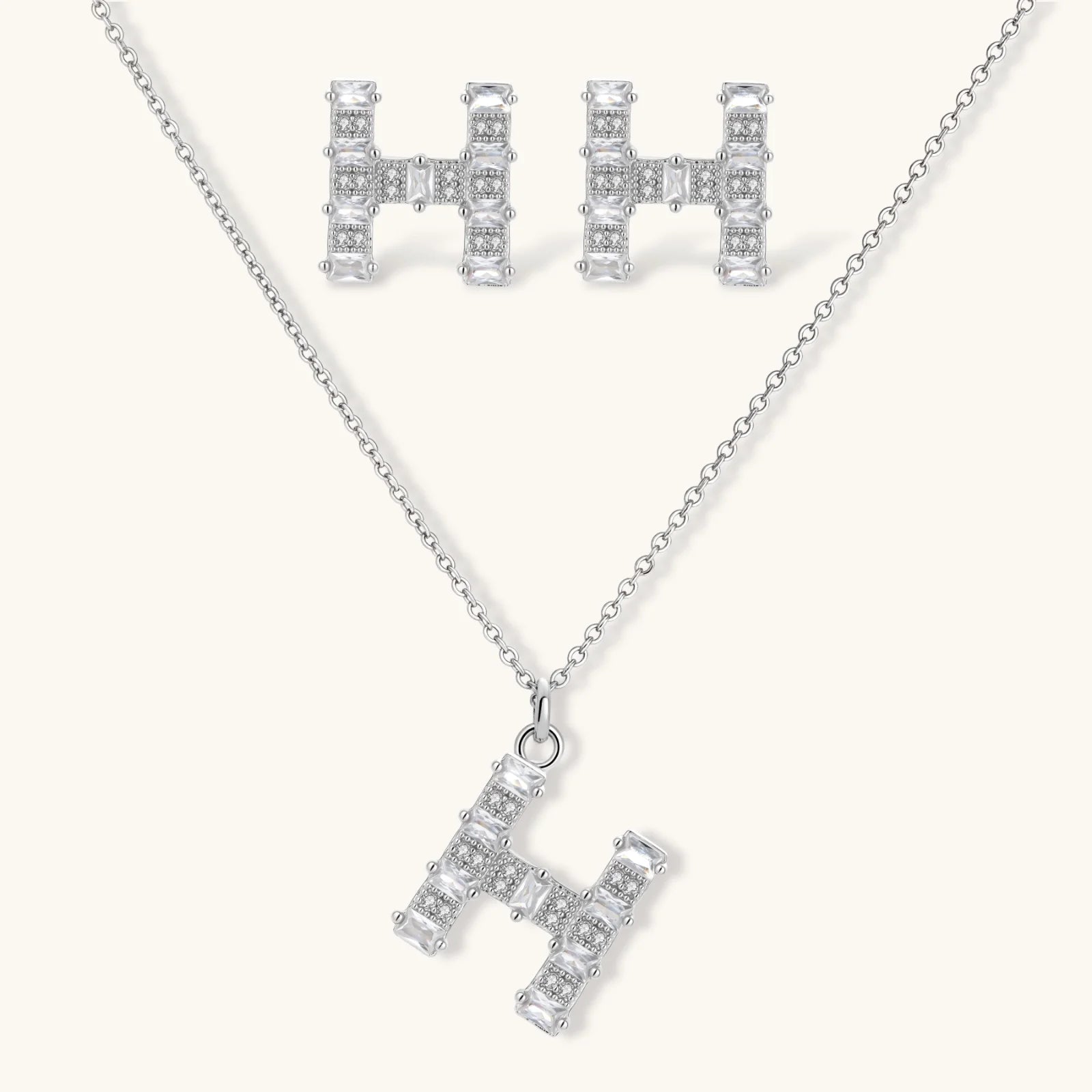Letter H jewelry set featuring geometric crystal design in gold and white gold plated finish with adjustable chain necklace