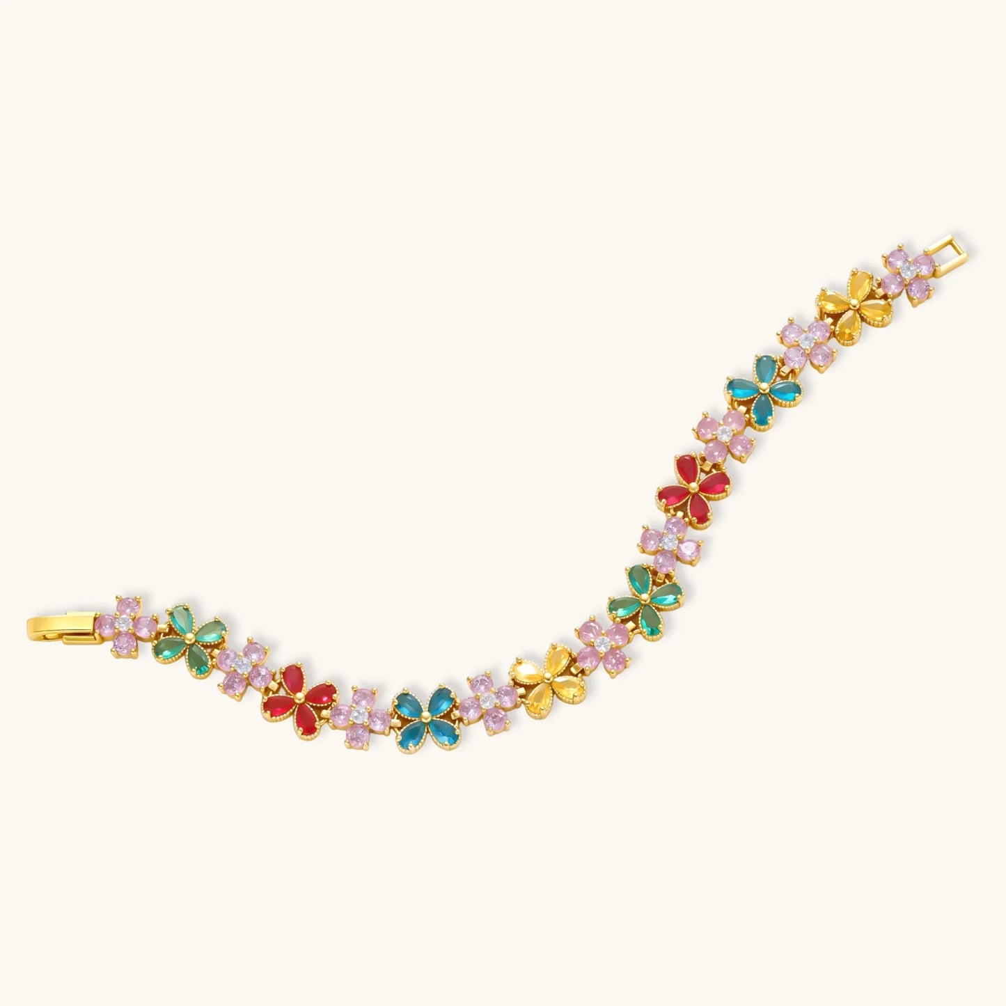 Gold-plated jewelry set with pink, turquoise and red flower-shaped cubic zirconia stones, featuring necklace, earrings and bracelet.