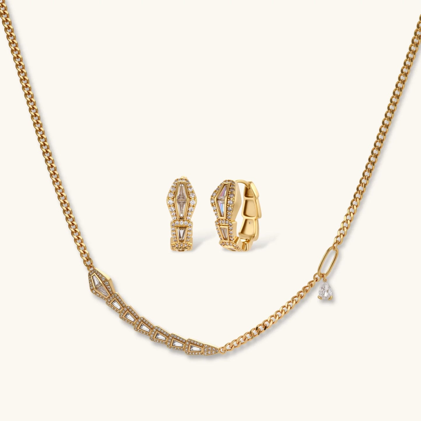 Gold-plated necklace with geometric diamond segments and matching huggie earrings featuring cubic zirconia details