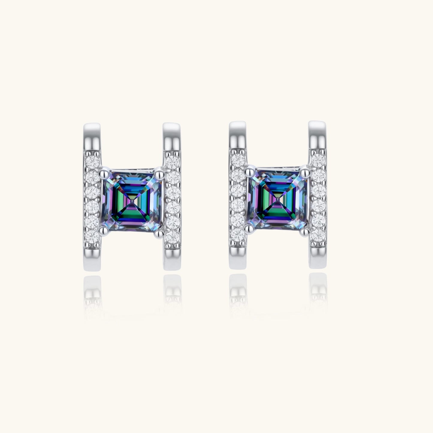 Square moissanite studs in sterling silver geometric setting showing rainbow prismatic fire on white background.