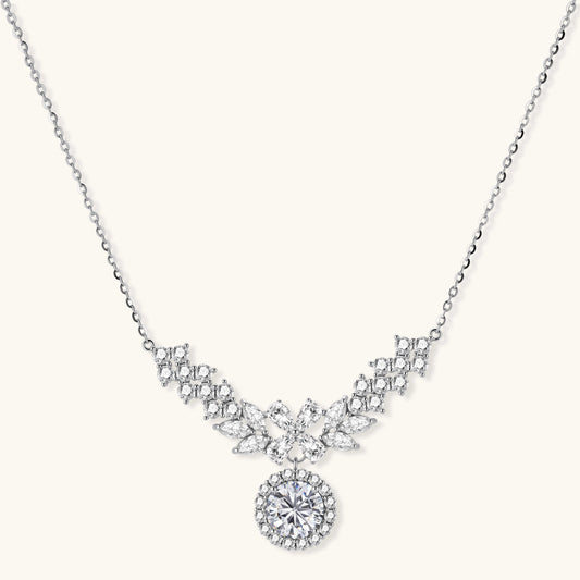 Elegant sterling silver necklace featuring intricate wing-like design with brilliant moissanite stones on neutral background.