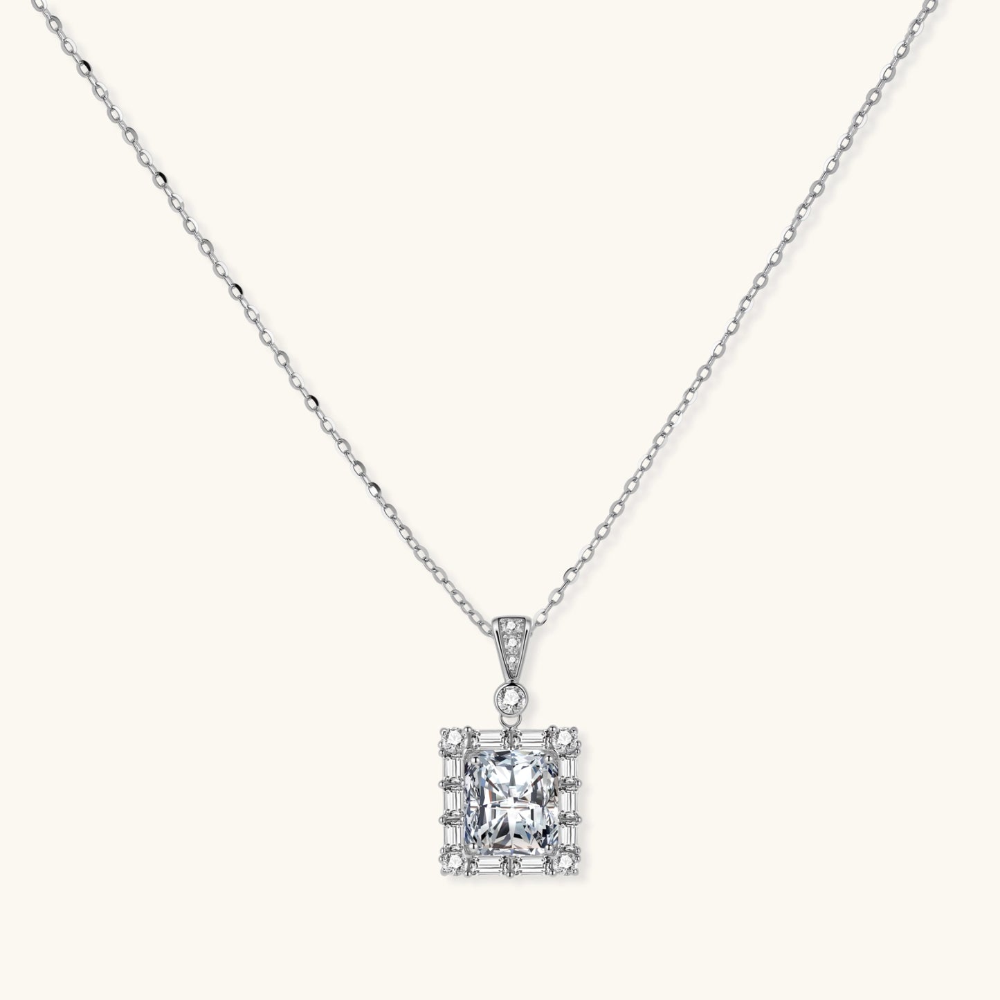 Square moissanite pendant with halo setting on delicate sterling silver chain against white background.