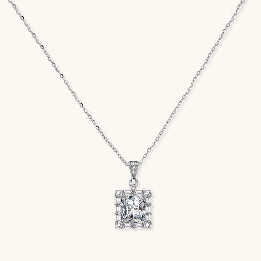Square moissanite pendant with halo setting on delicate sterling silver chain against white background.