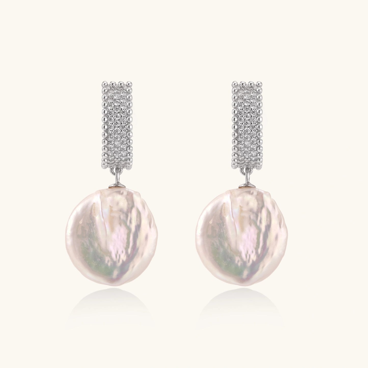 Rhodium-plated silver curved stud with pave stones and baroque pearl drop on white background