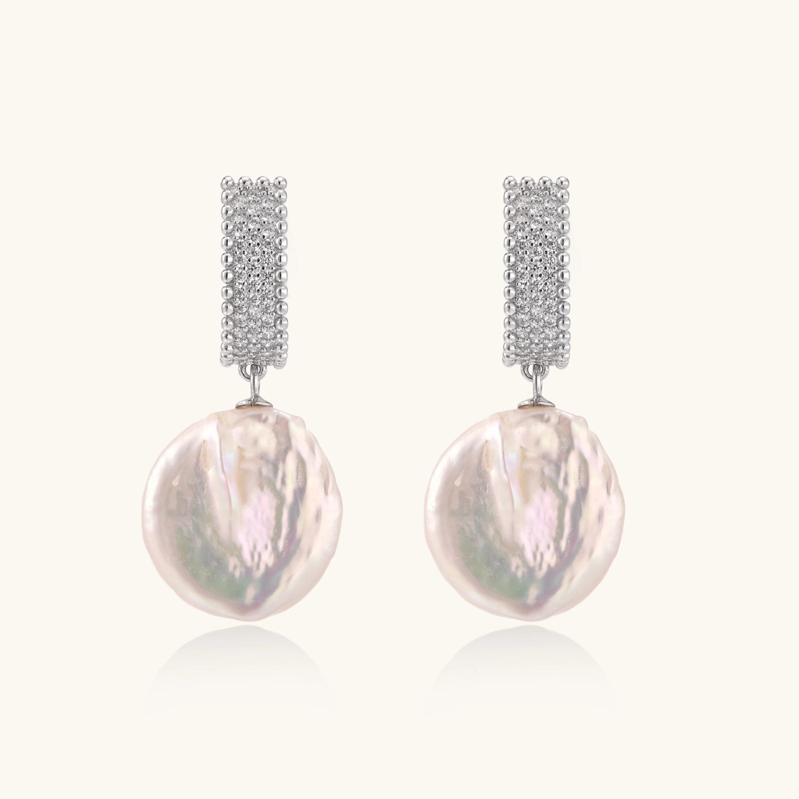 Rhodium-plated silver curved stud with pave stones and baroque pearl drop on white background