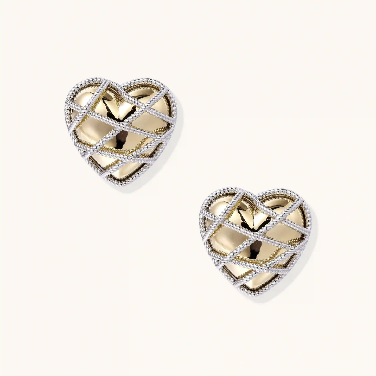 Heart-shaped stud earrings with intricate lattice design in 18K gold plated brass and silver-tone metal.