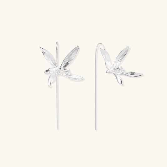 Delicate sterling silver dragonfly earrings with textured wings and curved threader hooks on white background