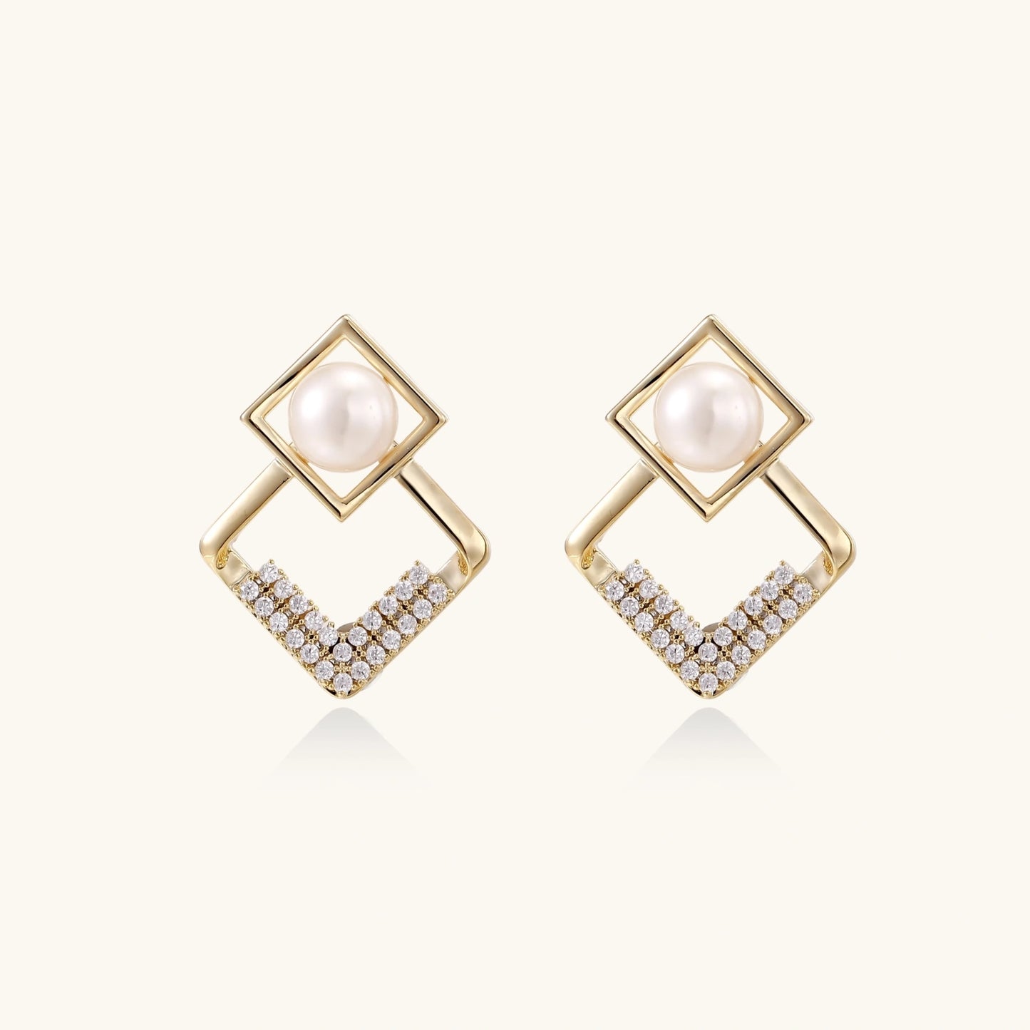 Gold-plated double square frame earrings with freshwater pearl and crystal accents on white background