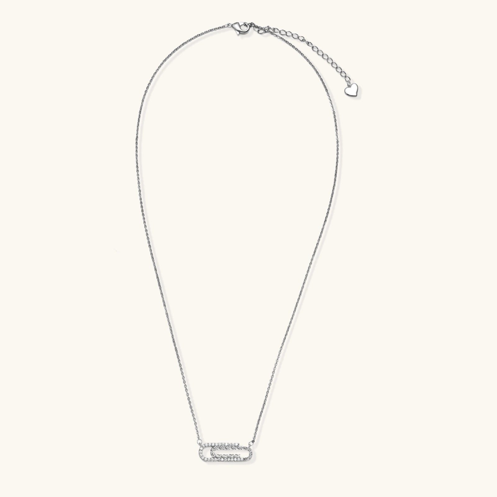 White gold plated necklace with dual-frame geometric pendant featuring crystal pavé border on pale background.