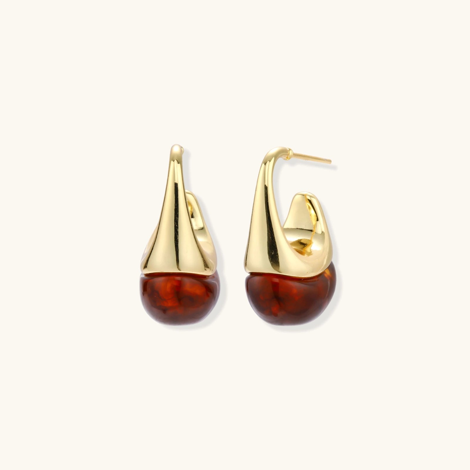 Modern drop earrings with curved gold-plated copper tops and amber resin bottoms creating an organic teardrop silhouette.