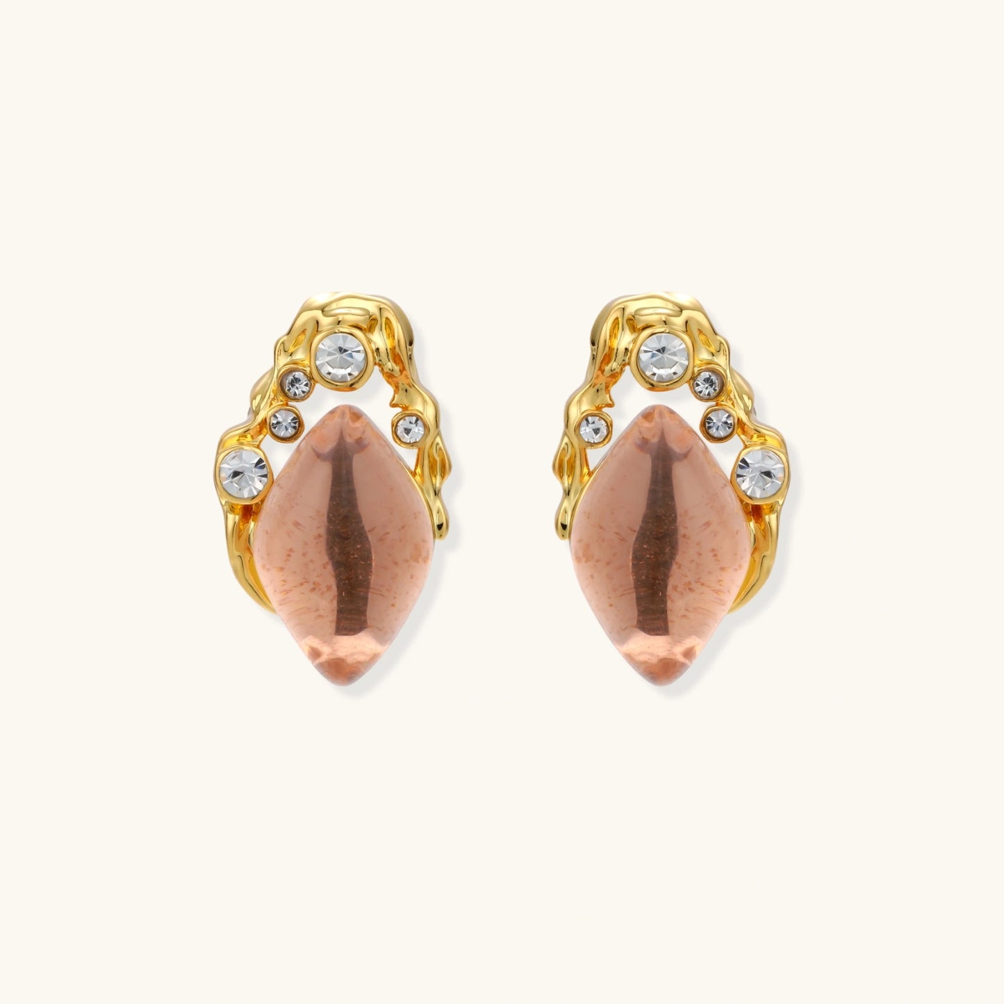 Gold-plated baroque stud earrings with coral-pink liuli stones and cubic zirconia crystals on white background.