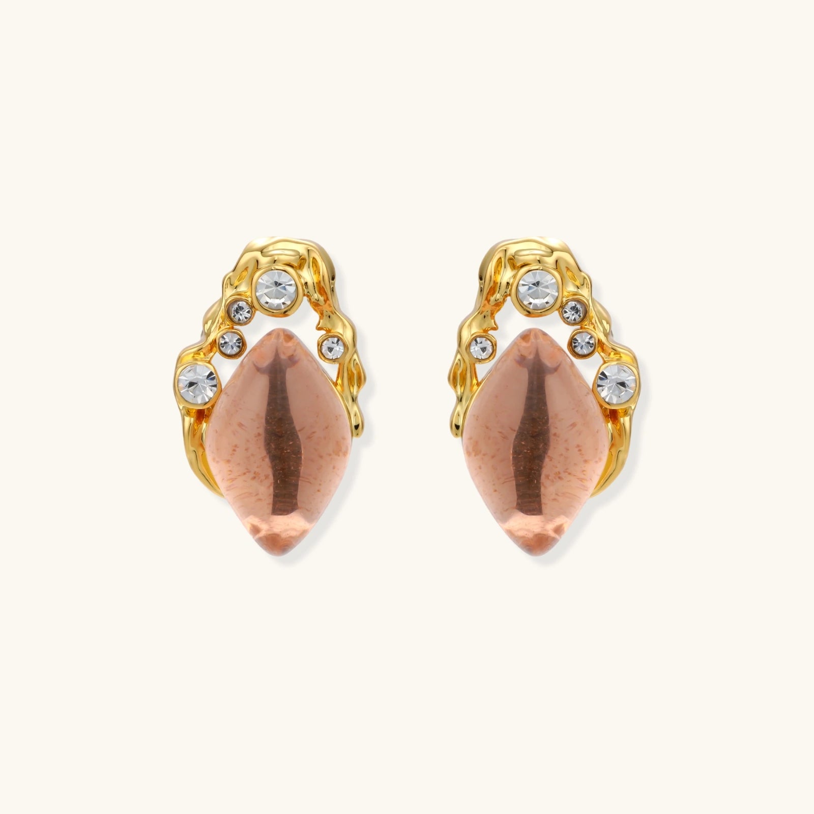 Gold-plated baroque stud earrings with coral-pink liuli stones and cubic zirconia crystals on white background.