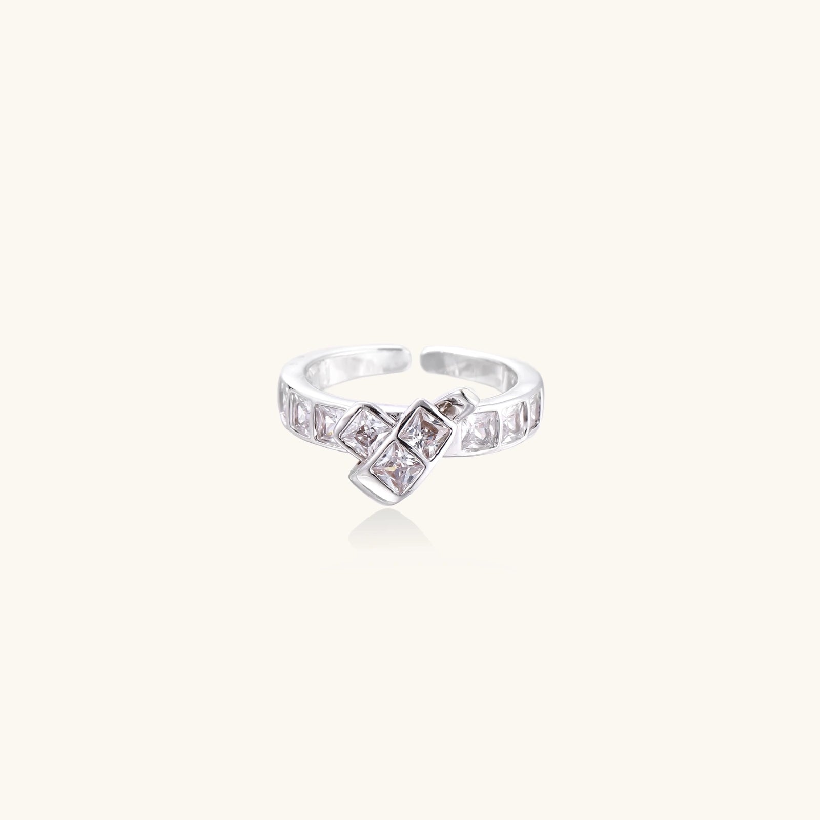 White gold plated adjustable ring featuring offset square cubic zirconia stones in an architectural stacked design
